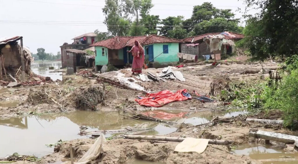 A woman standing amidst destroyed houses and land in Gaur Madesh province in Nepals lower Koshi river basin after flood ravaged the area